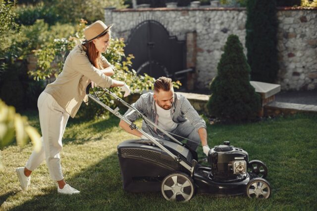 Lawn mower people working on the backyard