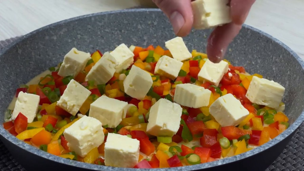 Zapečený cibulový koláč se zeleninou, sýrem feta, tvrdým sýrem a rajčaty ve tvaru pizzy