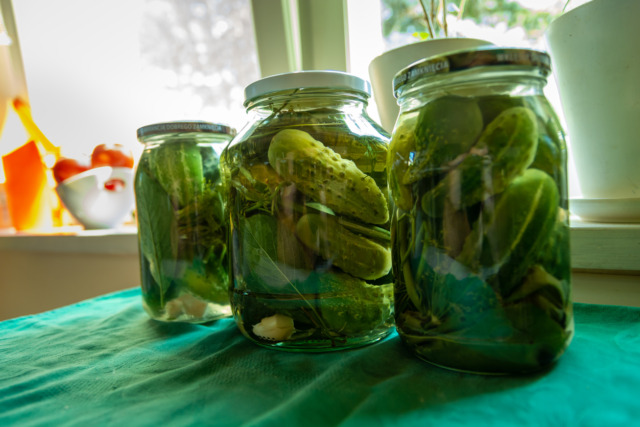 Jars with pickled cucumbers on the countertop