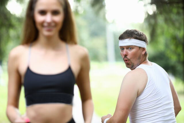 Obese man doing morning jogging in park