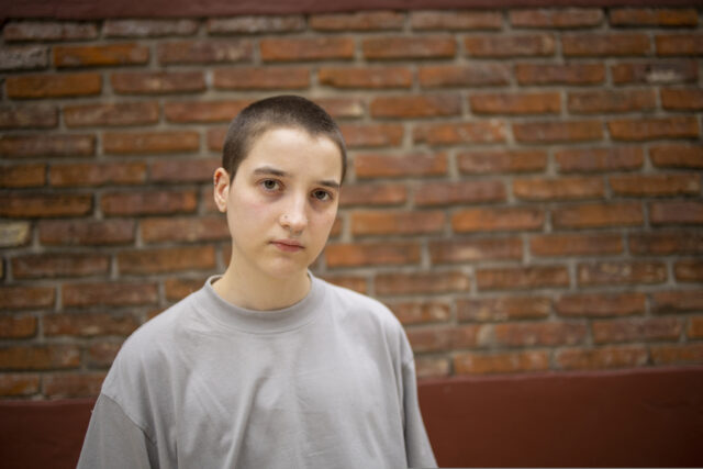 Portrait of Latin transgender generation z person with the short hair looking at the camera.