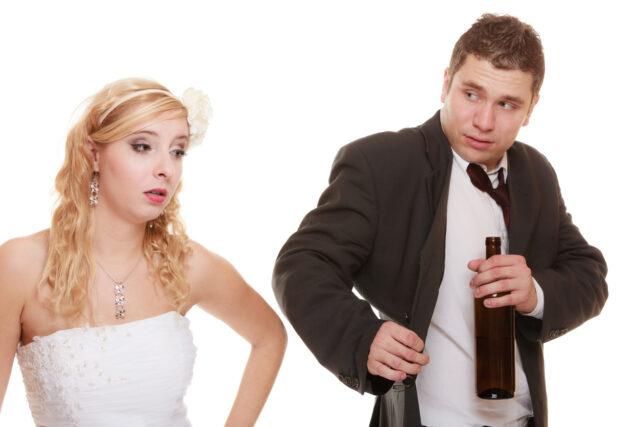 Wedding couple, bride with alcoholic drinking groom.