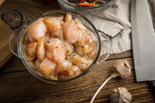 Raw chicken fillet breast cut into pieces.