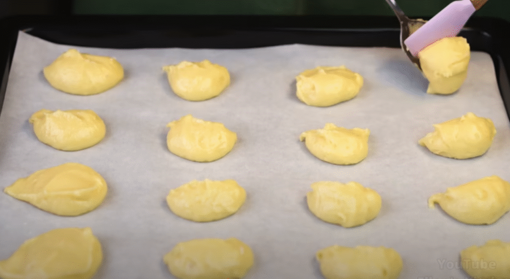 Jemné koláčky s krémem ze zakysané smetany a kondenzovaného mléka s čokoládovým přelivem