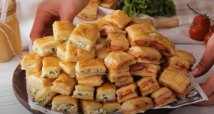 Jednoduché slané jednohubky z listového těsta: recept, který nikdy nezklame (hotové za 25 minut) Slané jednohubky z listového těsta plněné párkem a sýrem