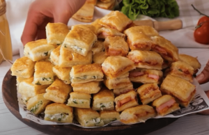 Jednoduché slané jednohubky z listového těsta: recept, který nikdy nezklame Slané jednohubky z listového těsta plněné párkem a sýrem