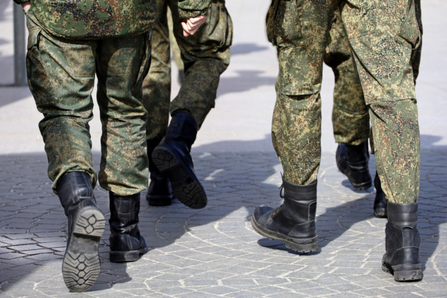 Legs of soldiers of military forces in camouflage