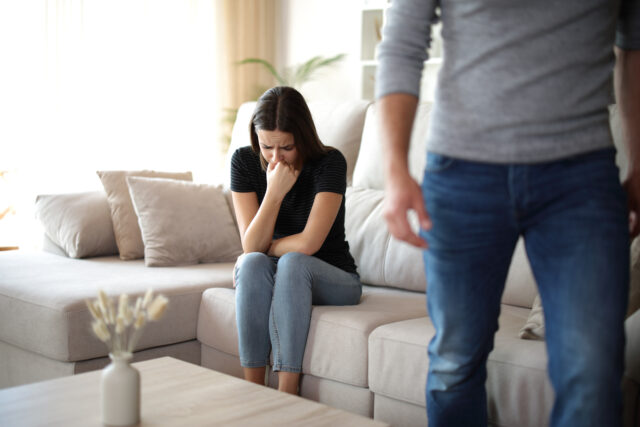 Boyfriend leaving his sad girlfriend at home