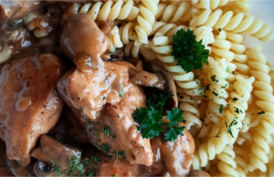 Šťavnaté kuře na žampionech: Rychlá a poctivá klasika, která nikdy nezklame Talíř se šťavnatými kousky kuřete v žampionové omáčce, podávaný s kopečkem rýže a posypaný čerstvou petrželkou.